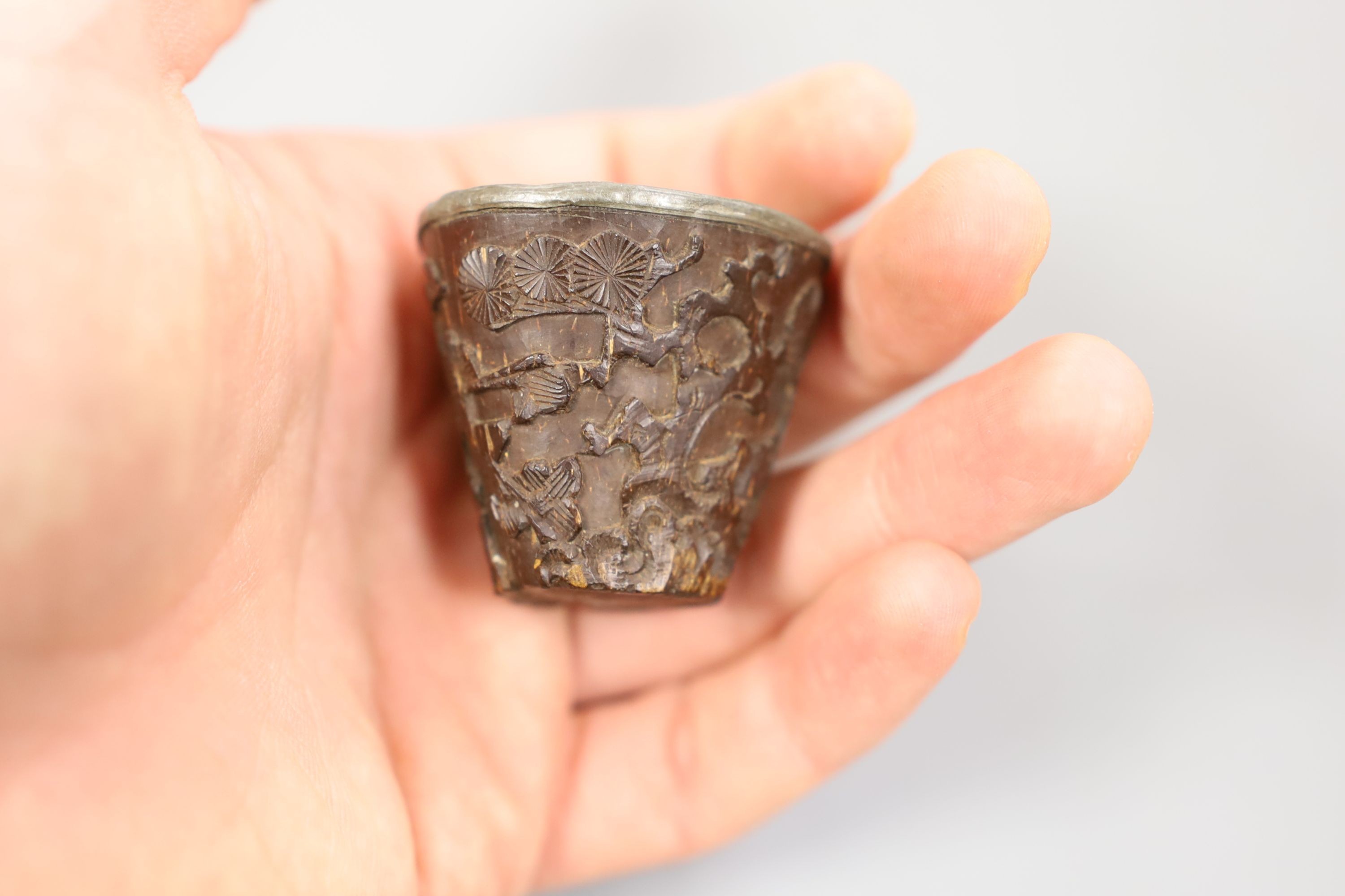 A Chinese or Japanese ivory lion dog 18th/19th century and a Chinese carved nut cup, 19th century. 4cm